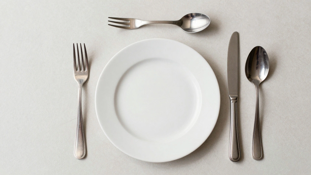 Overhead view of a formal place setting with fork, knife, and spoons